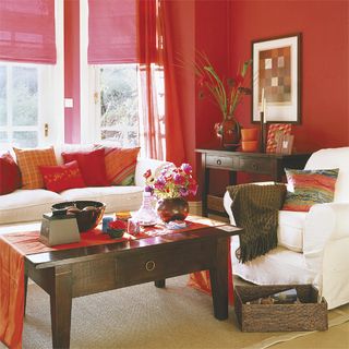 Red living room with white sofa and pink blinds