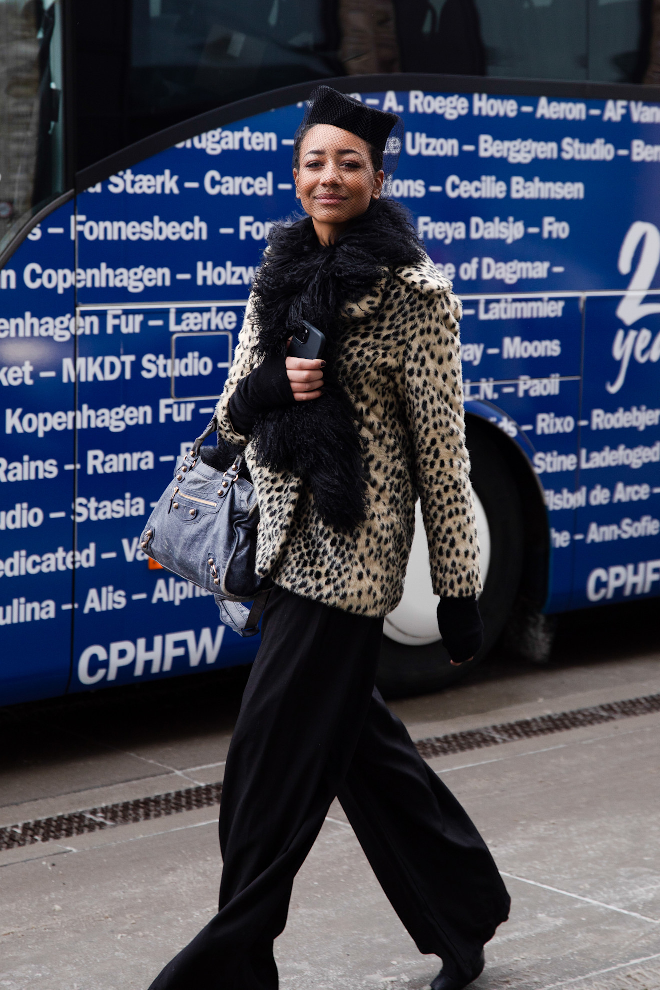 a guest at copenhagen fashion week wearing a leopard print coat