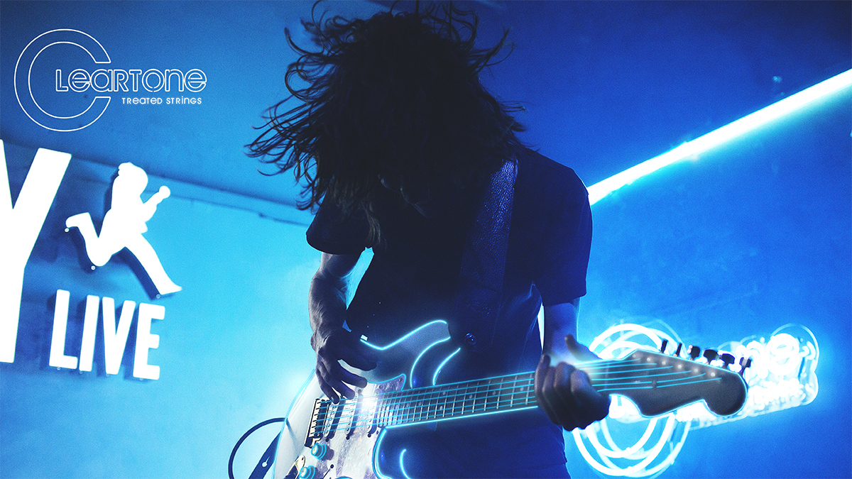 A guitarist playing a Fender Strat equipped with cleartone strings