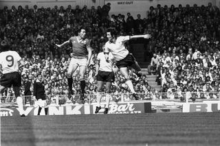 Stuart Pearson jumps up for a header with Jimmy Case during an FA Cup final between Manchester United and Liverpool which United won 2-1.