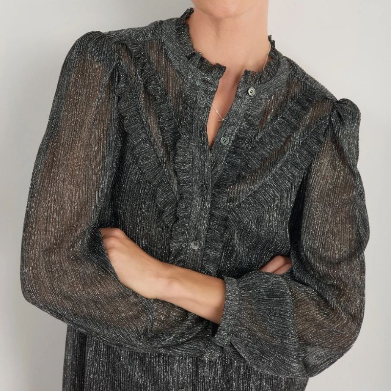 A model wears a pewter shimmer blouse by Wyse