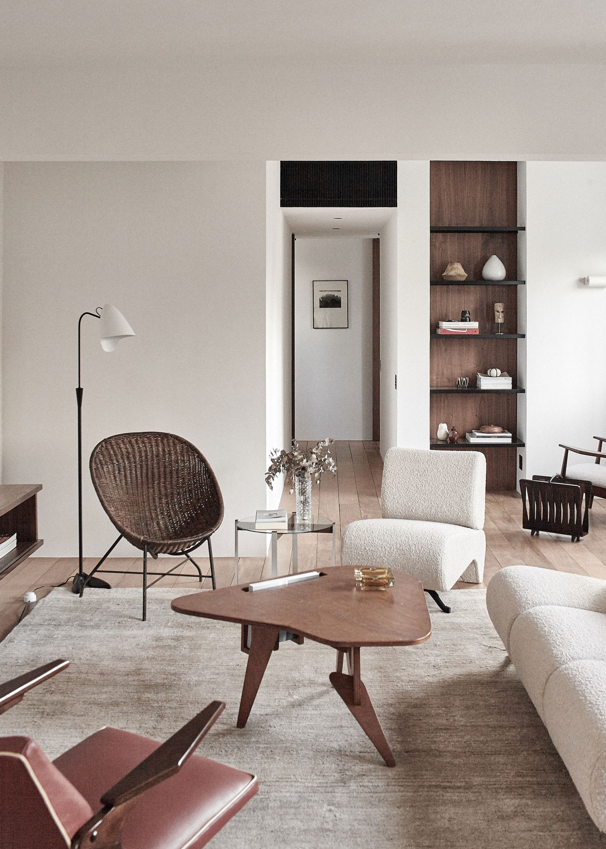 a modern neutral apartment design with boucle furniture and organic wood coffee table