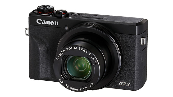 Canon compact camera against a white background