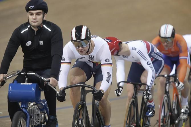 Jason Kenny checks the competition behind Germany's Tobias Wachter.
