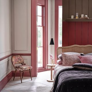 bedroom wall decor ideas, bedroom with pale grey walls, mid pink painted woodwork, false wall behind bed painted in red and brown, rattan bed, berry bedding