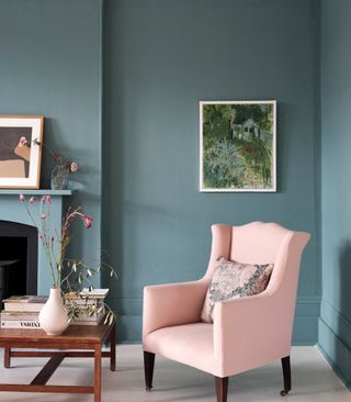 Blue living room with pink armchair