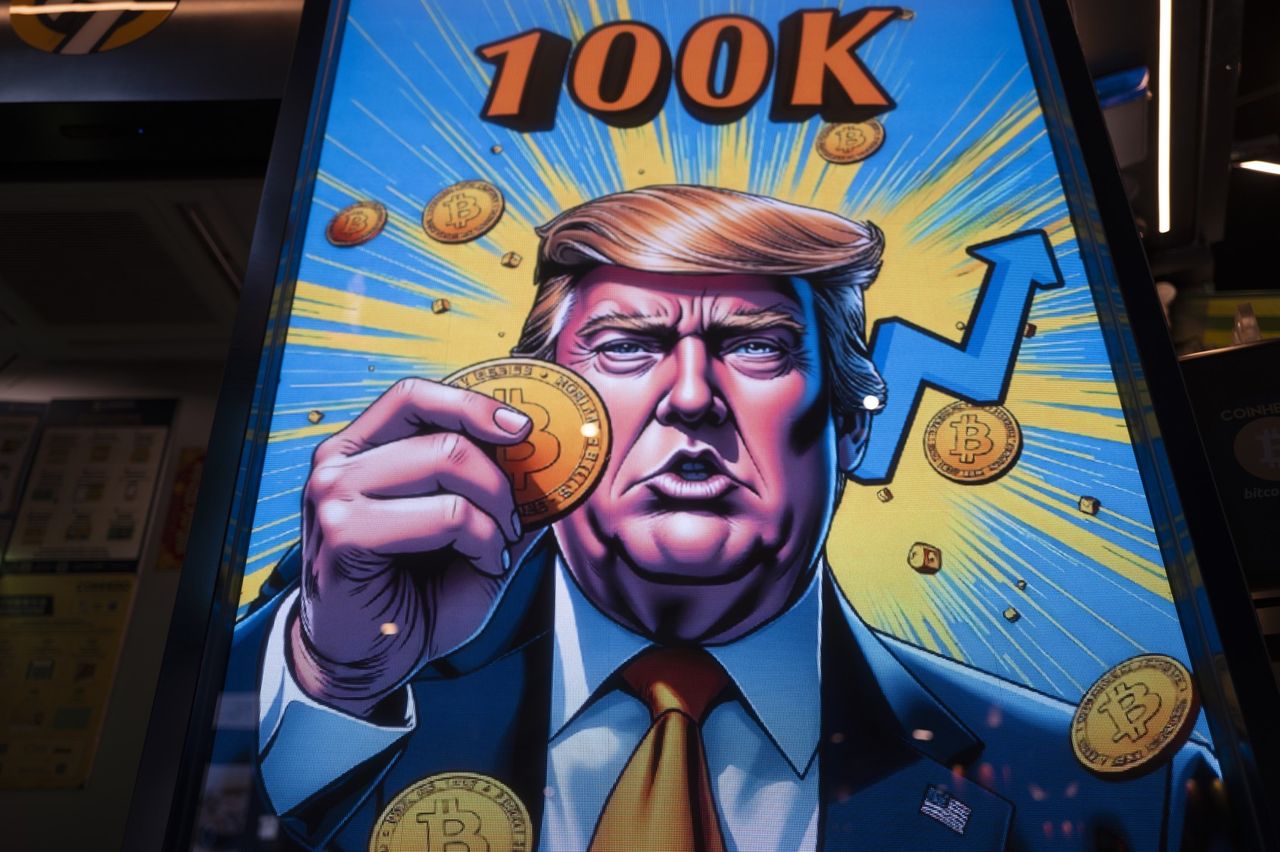 A cartoon image of US President-elect Donald Trump holding a Bitcoin token to mark the cryptocurrency reaching over $100,000 displayed at a Coinhero store in Hong Kong, China, on in Hong Kong, China, on Thursday, Dec. 5, 2024. Trump&#039;s pick of a crypto proponent to be the next head of the US securities regulator liftedBitcointo $100,000 for the first time as traders warmed to the prospect of relaxed regulations.