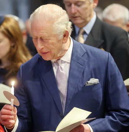 King Charles holding a candle