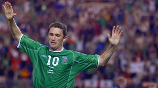 KASHIMA, JAPAN: Irish forward Robbie Keane reacts after he scored a goal during the Group E first round match Germany/Ireland of the 2002 FIFA World Cup in Korea and Japan, 05 June 2001 at Kashima Ibaraki Stadium. The game ended in a draw 1-1. AFP PHOTO ODD ANDERSEN (Photo credit should read Odd Andersen/AFP via Getty Images)