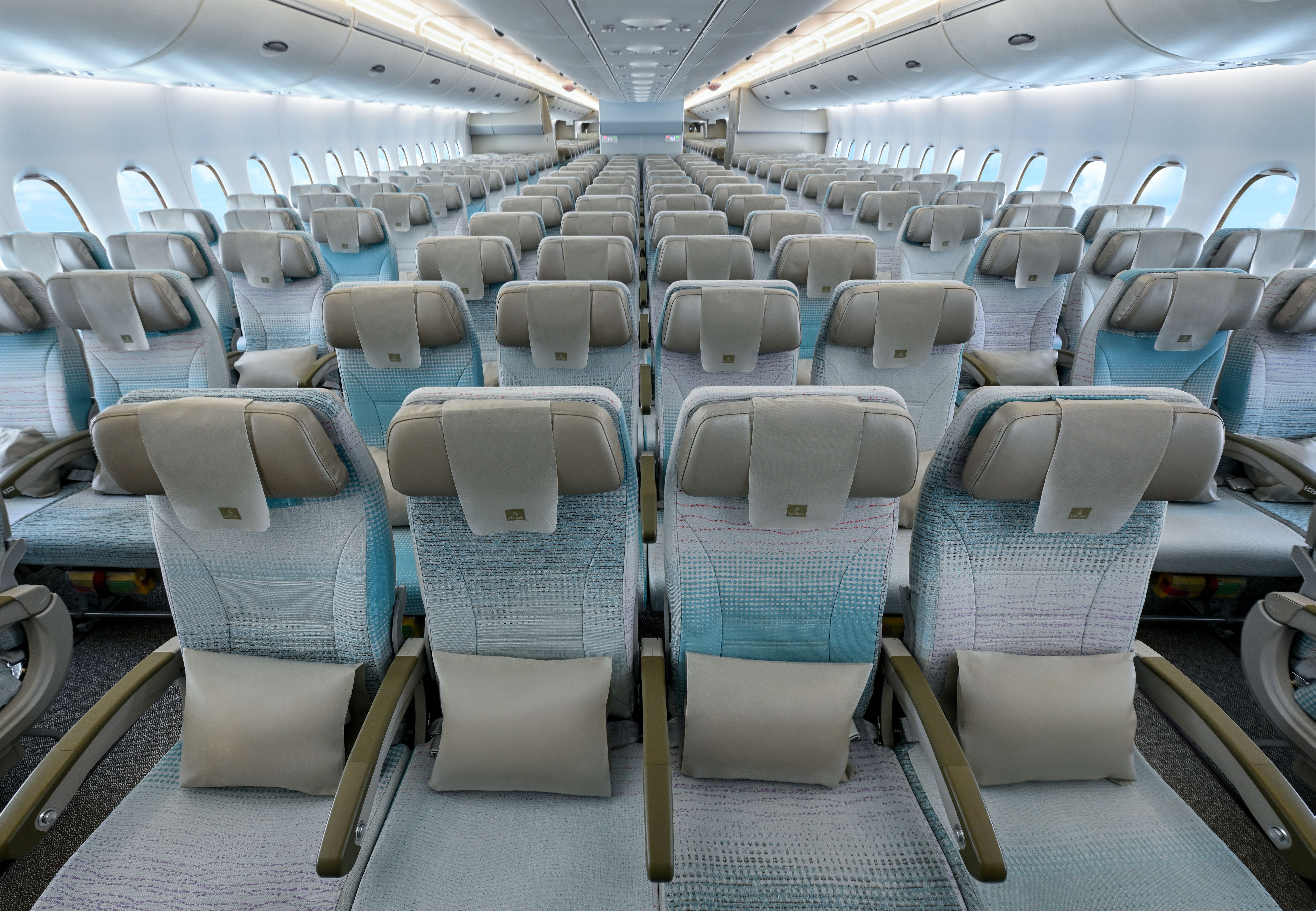 view of the interior of an aeroplane cabin featuring a beige design