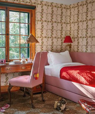 single guest bed with storage in office room with patterned wallpaper and desk and chair