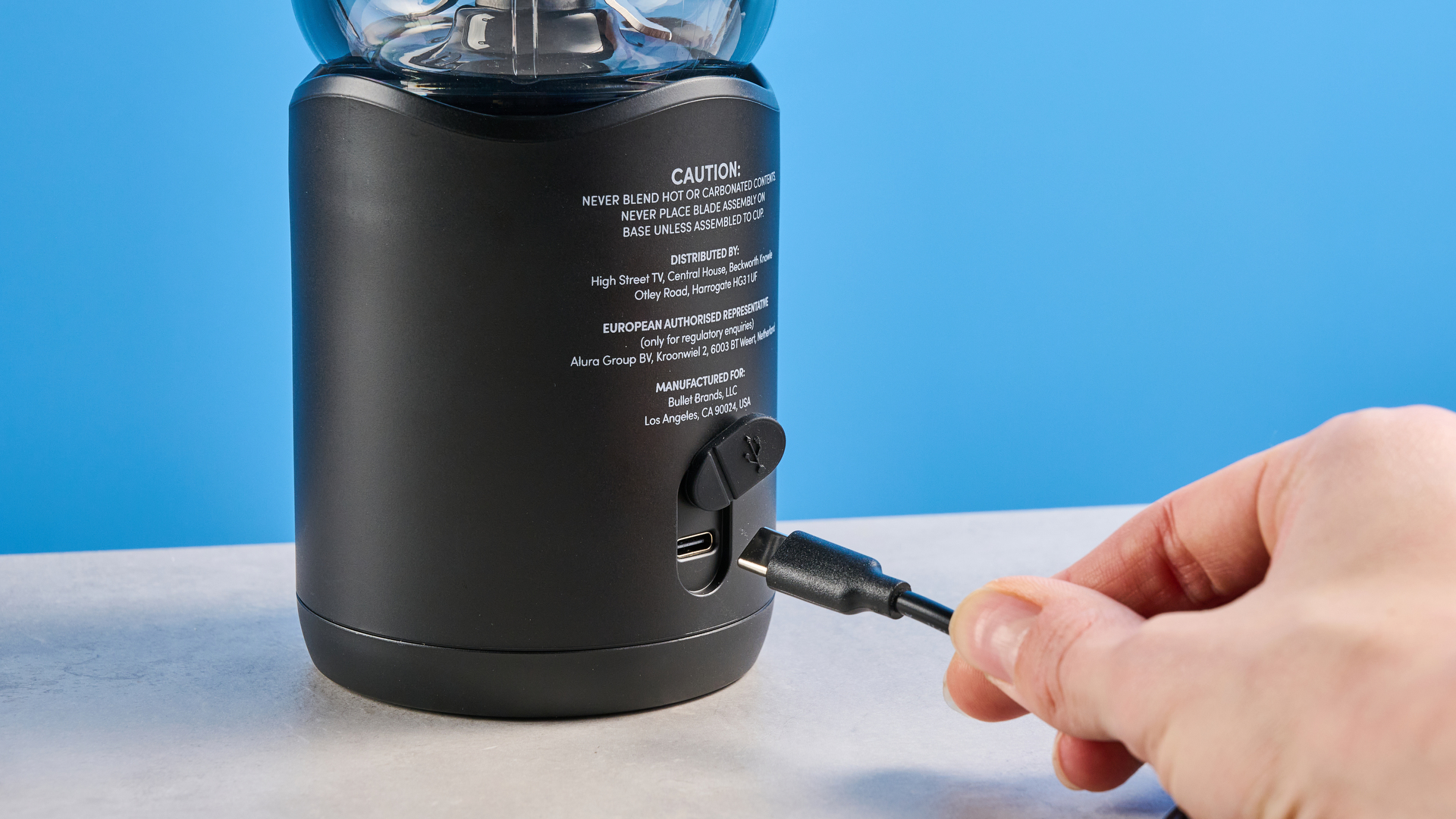 Nutribullet Flex blender photographed on a blue background