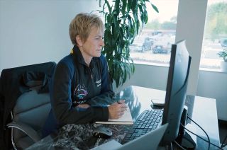 Axiom Space director of human spaceflight Peggy Whitson is seen taking notes using a new Axiom-branded Fisher Space Pen as she prepares to command the Ax-2 private mission.
