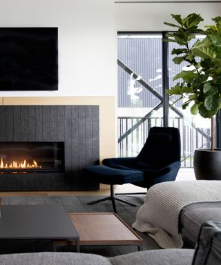 A moody living room with a fire place and tv