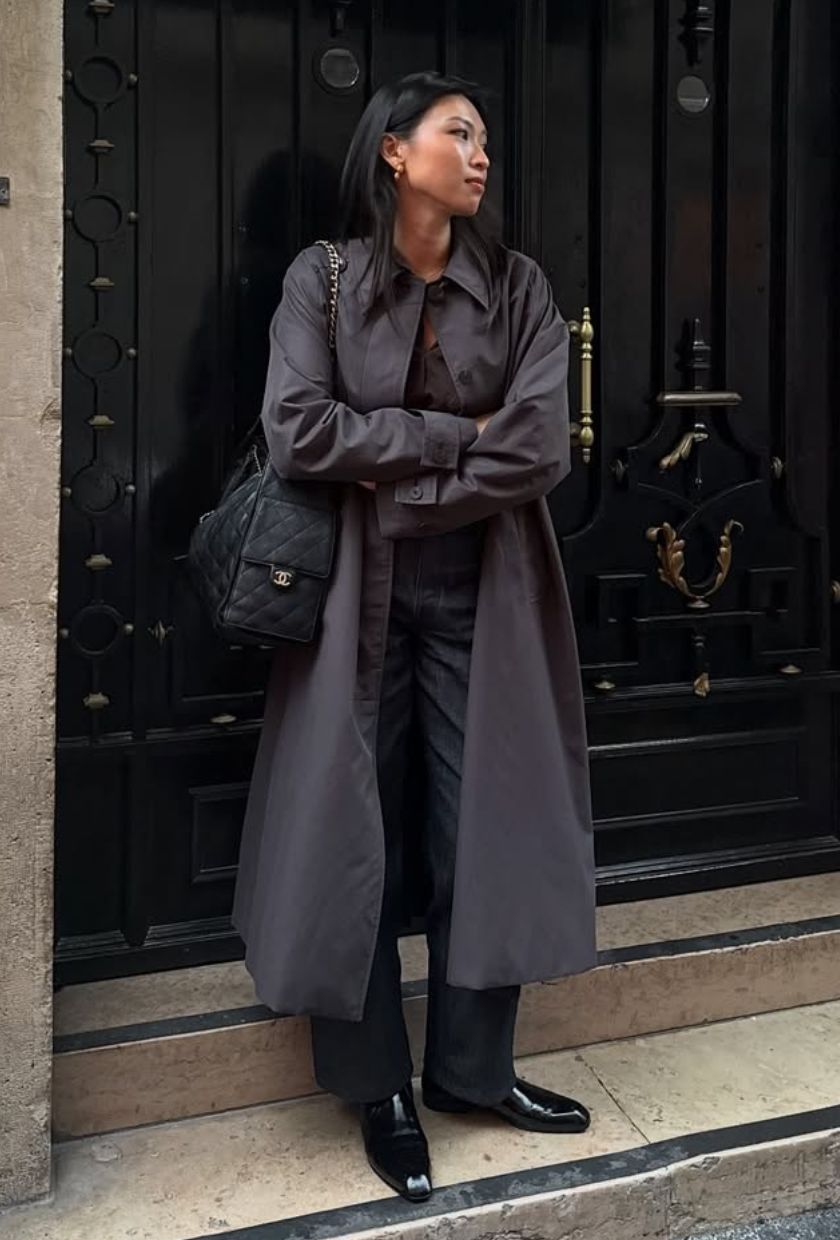 @michellelin.lin wears a car coat, black trousers, boots and a black leather quilted bag