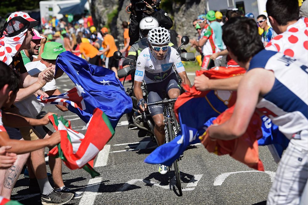 Nairo Quintana climbs through a tunnel of spectators.