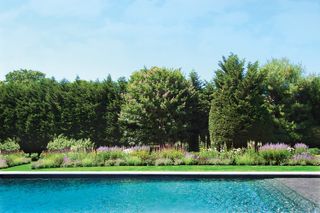 pool landscaping ideas with flower beds alongside the pool