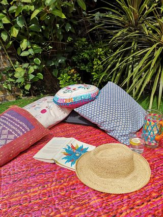 colourful outdoor rug used as a picnic blanket in a garden