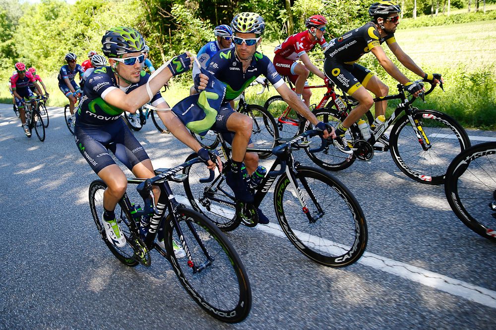 Movistar riders share a mussette during stage 1