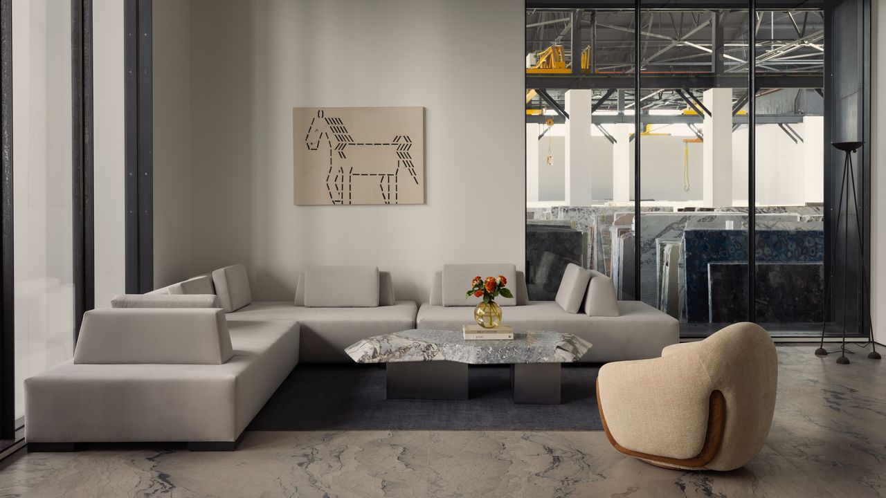 Living room set up in stone showroom with grey sofa and stone coffee table