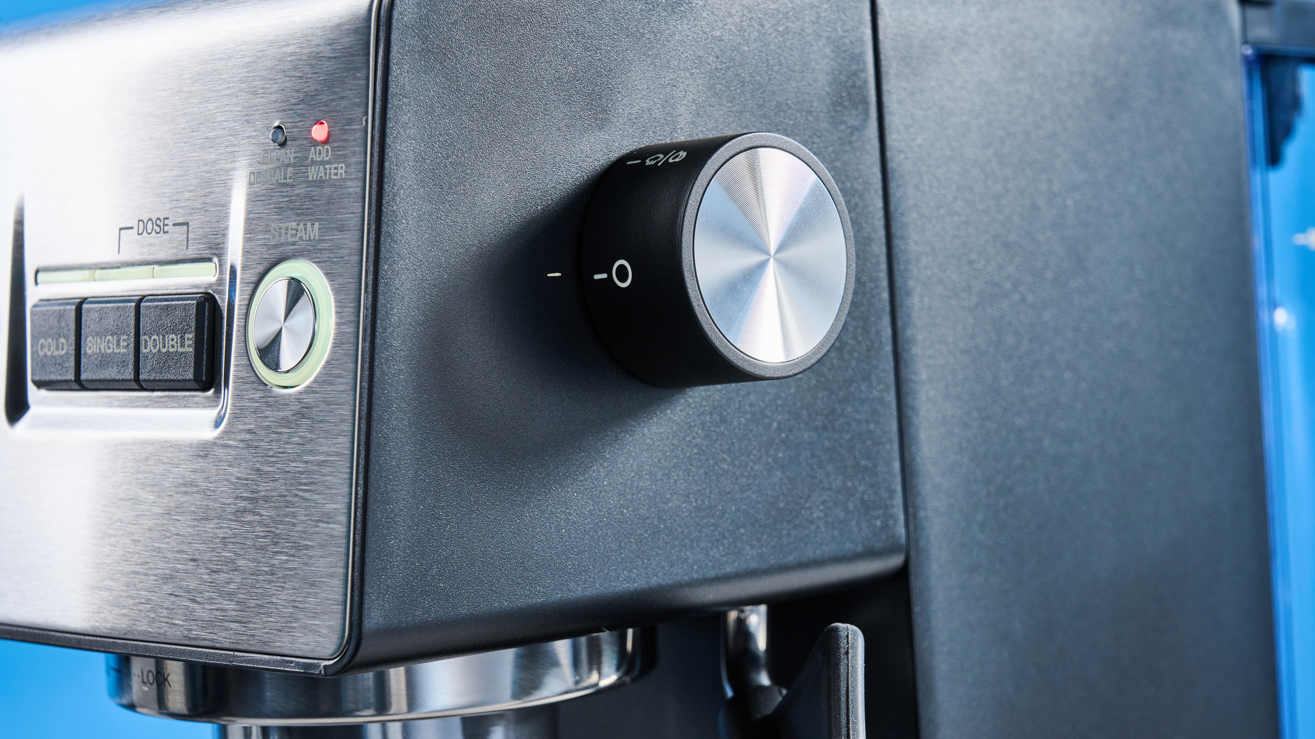 The Cuisinart Espresso Bar Slim espresso machine on a stone surface with a blue background