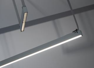 Flat, long grey lights shown from two different perspectives, hanging from textile ropes