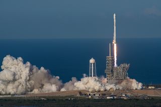 A SpaceX Falcon 9 rocket with a used first stage launches the SES-10 communications satellite from Kennedy Space Center in Florida on March 30, 2017.