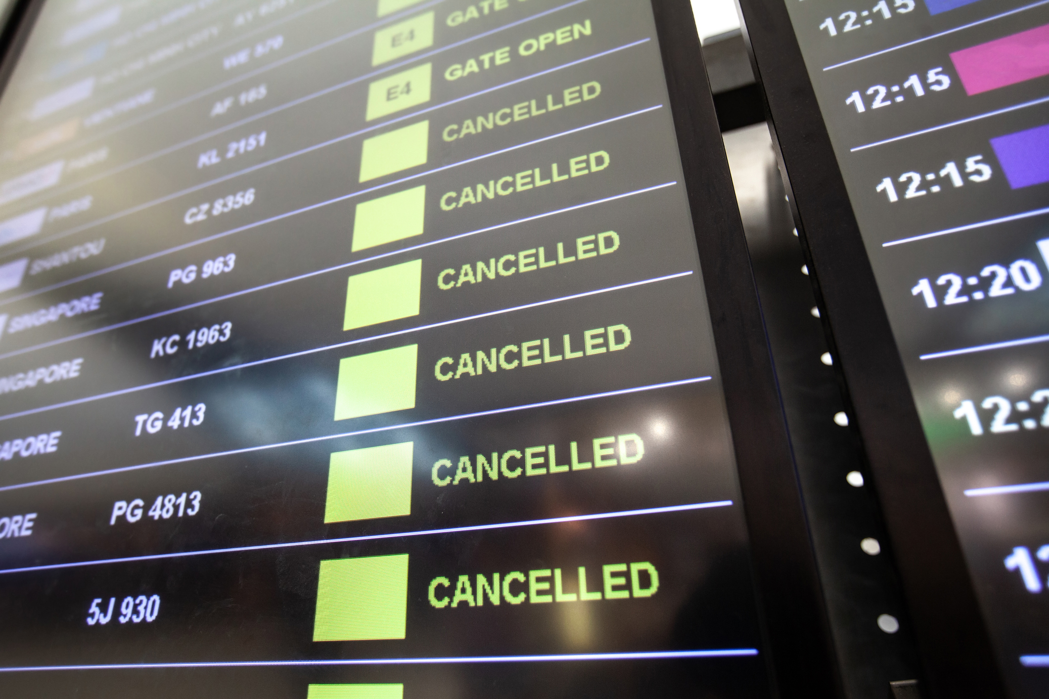 Flight cancellations in airport on departure board screen