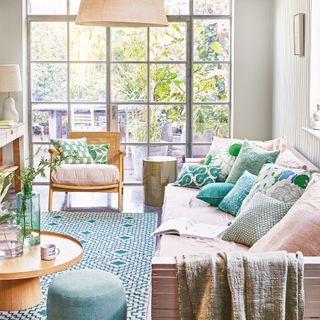 living room with neutral sofa with green cushions