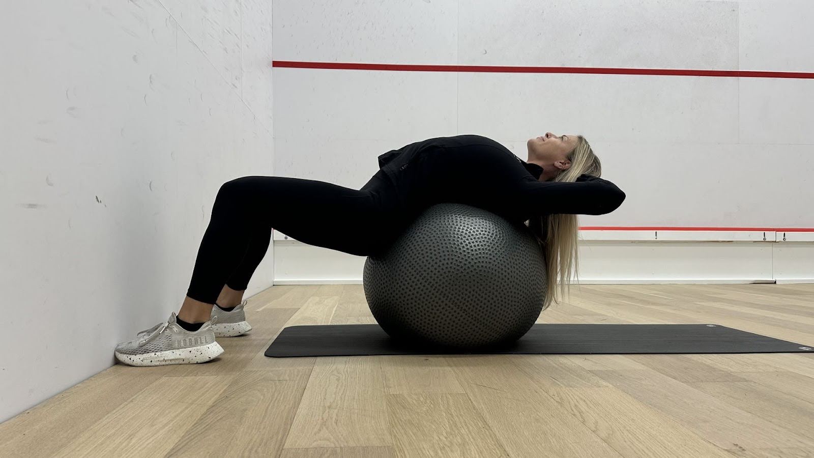 Woman demonstrates stretches in a fitness studio