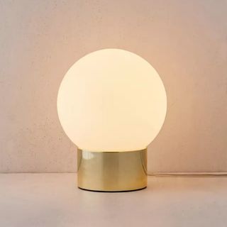 A softly lit globe lamp