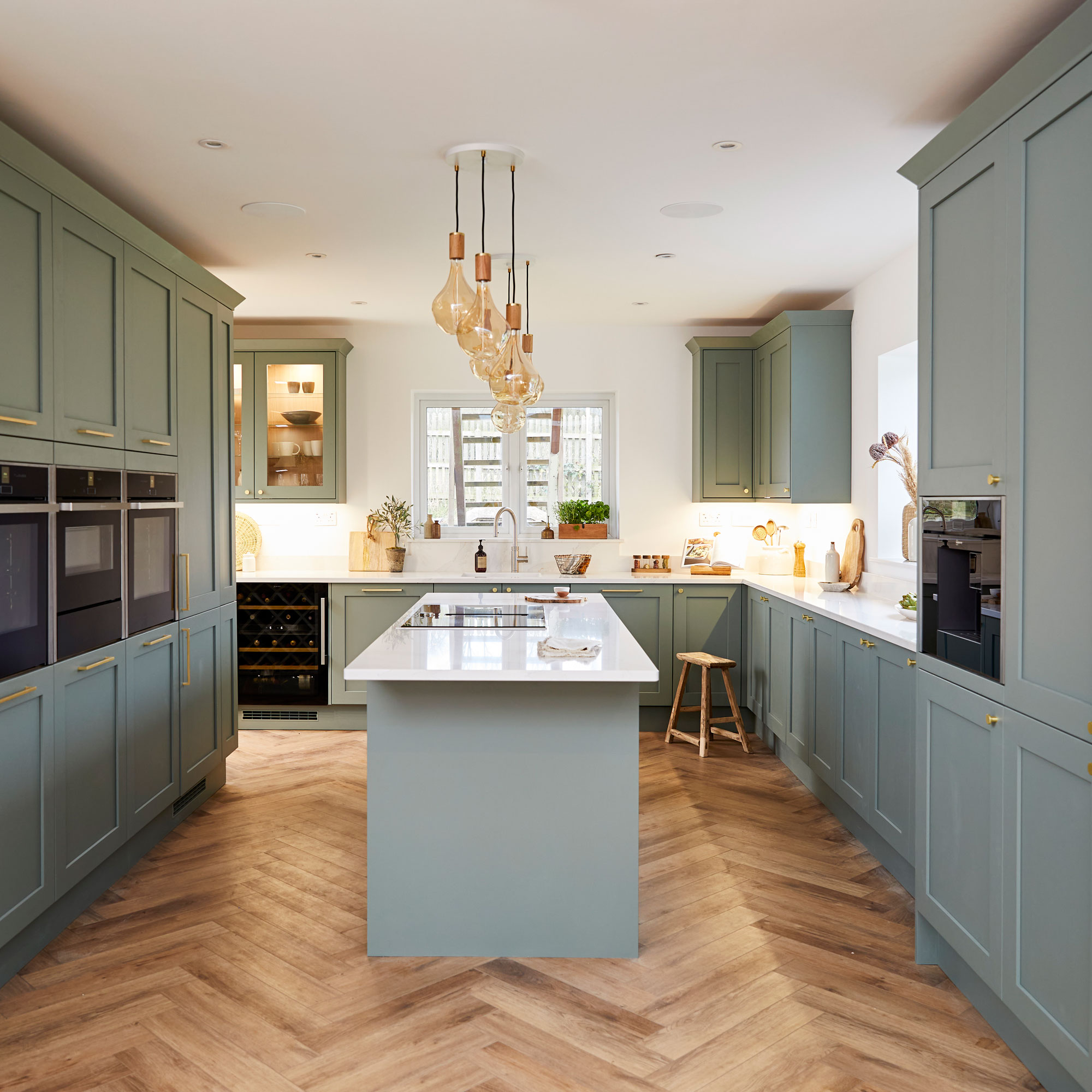 Greg Rutherford's kitchen with green cabinetry and a kitchen island