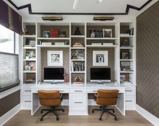 Home office with double built in desk with shelving in white above