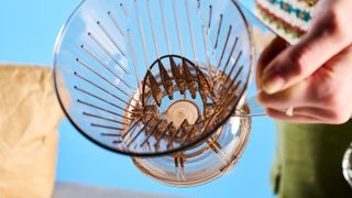 the clever dripper, a brown transparent plastic manual coffee maker with a handle and a sluice feature in the bottom to keep water inside