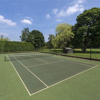 Tennis court with trees and sky