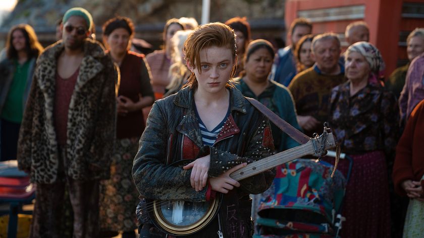 Sadie Sink&#039;s O&#039;Dessa holding a guitar in front a crowd in O&#039;Dessa