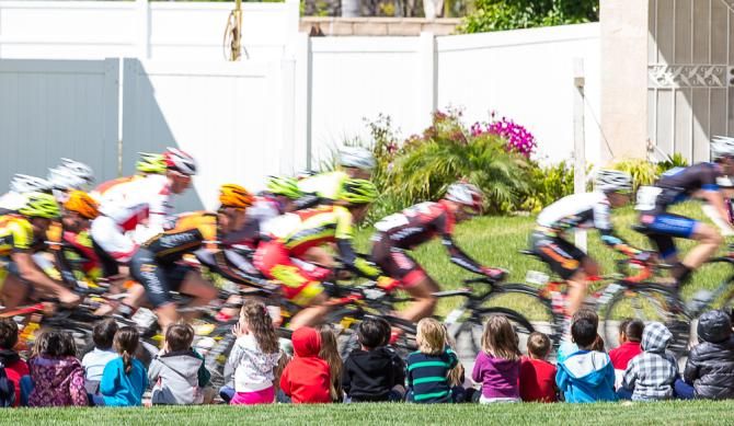 A local kindegarten cheers on the peloton
