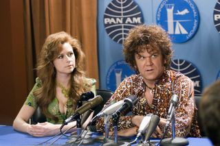 jenna fischer and john c reilly at a press conference table in 60s clothes in the movie walk hard