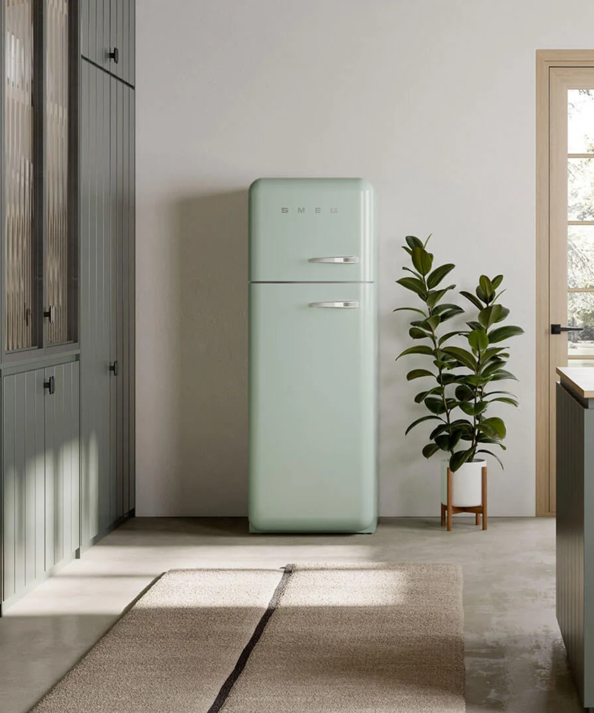 A pastel green Smeg refrigerator standing in an English country-style kitchen
