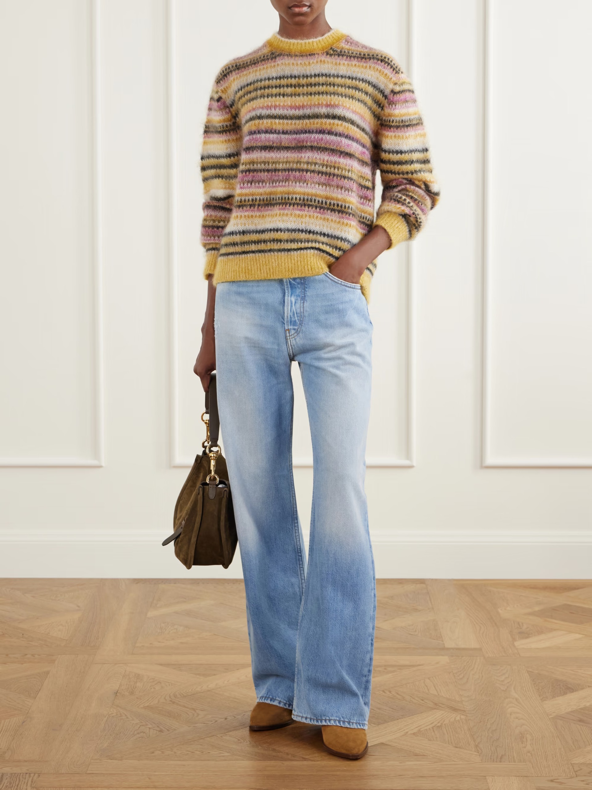 A model wearing an Isabel Marant jumper with yellow, pink, black and cream stripes