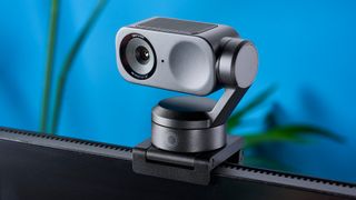 a photograph of a small grey 4K webcam with a gimbal and PTZ functionality