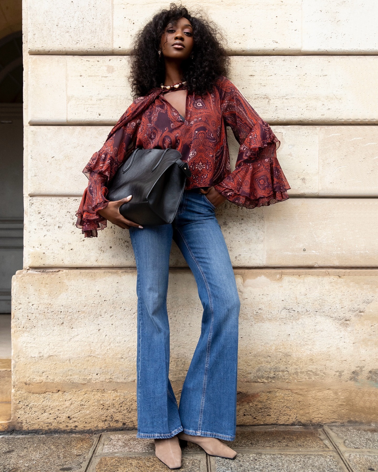 Woman in flared leg jeans.