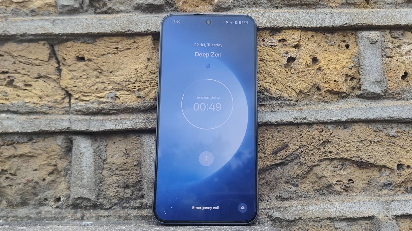 The OnePlus Nord 5 against a brick wall.