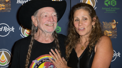 Willie Nelson and Annie D'Angelo attend Hard Rock International's Wille Nelson Artist Spotlight Benefit Concer at Hard Rock Cafe, Times Square on June 6, 2013 in New York City