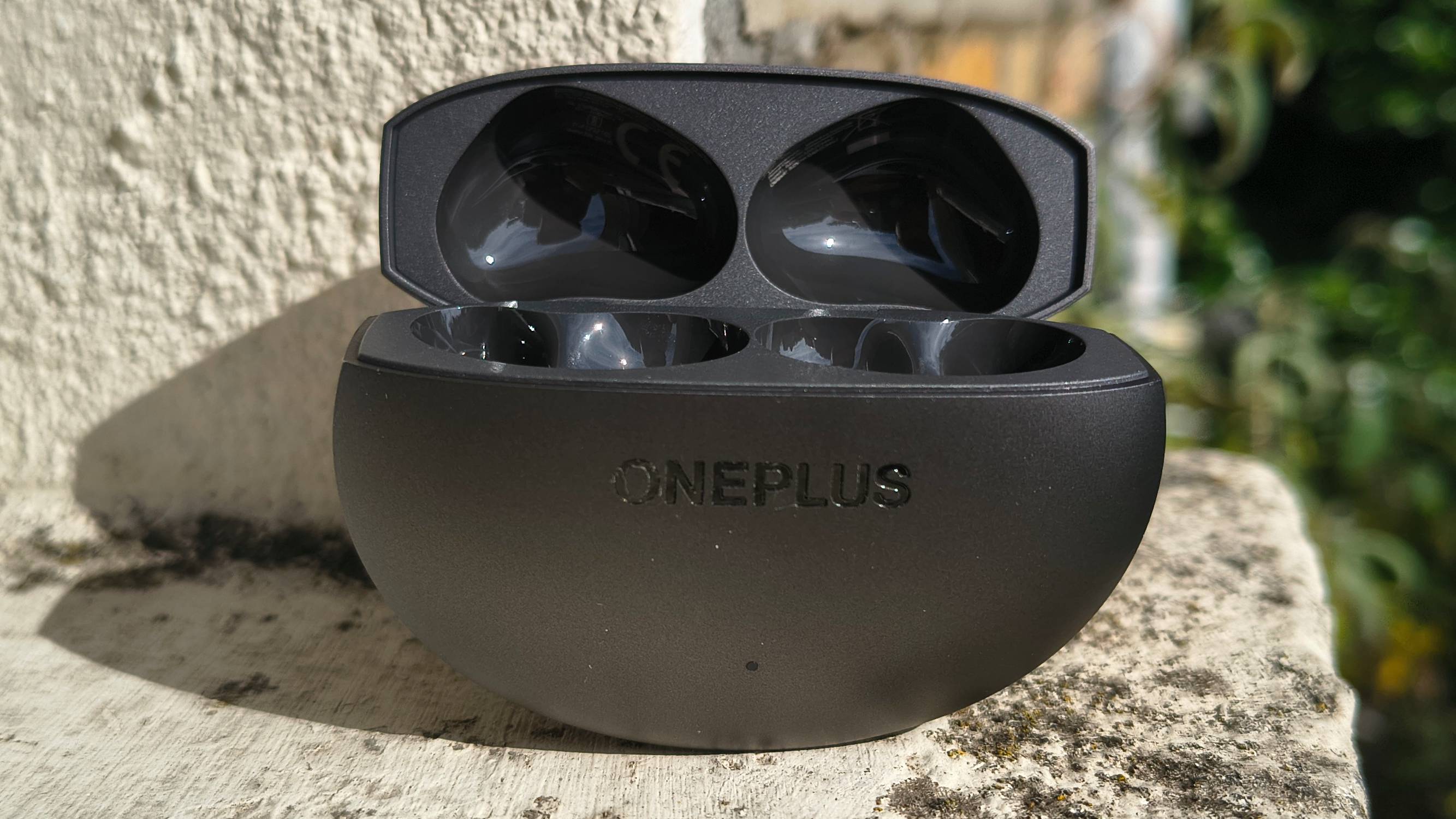 The OnePlus Buds 4 on a window sill.
