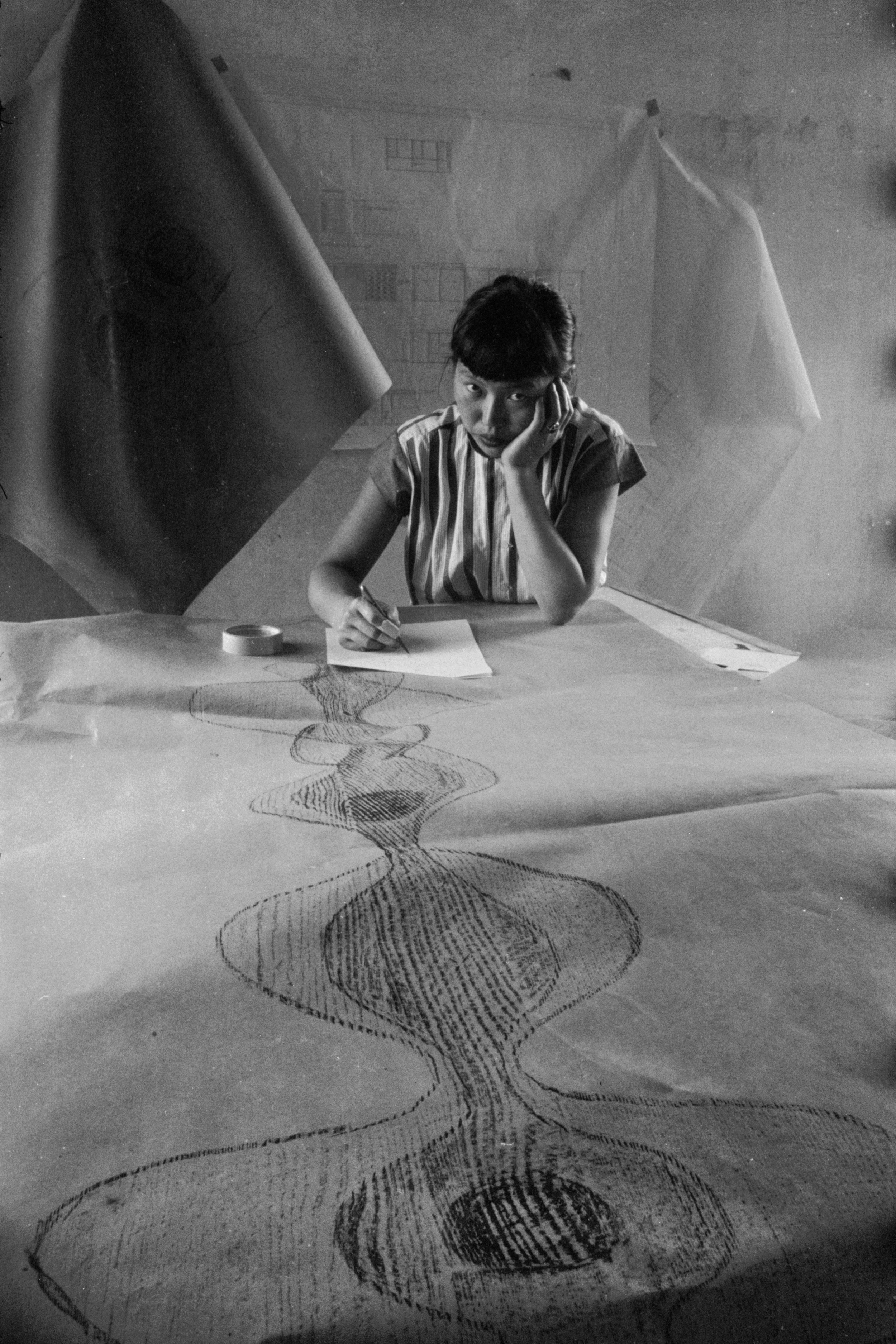 Ruth Asawa as she sketches a design