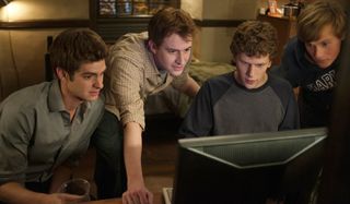 The Social Network Jesse Eisenberg and his friends crowd around a monitor