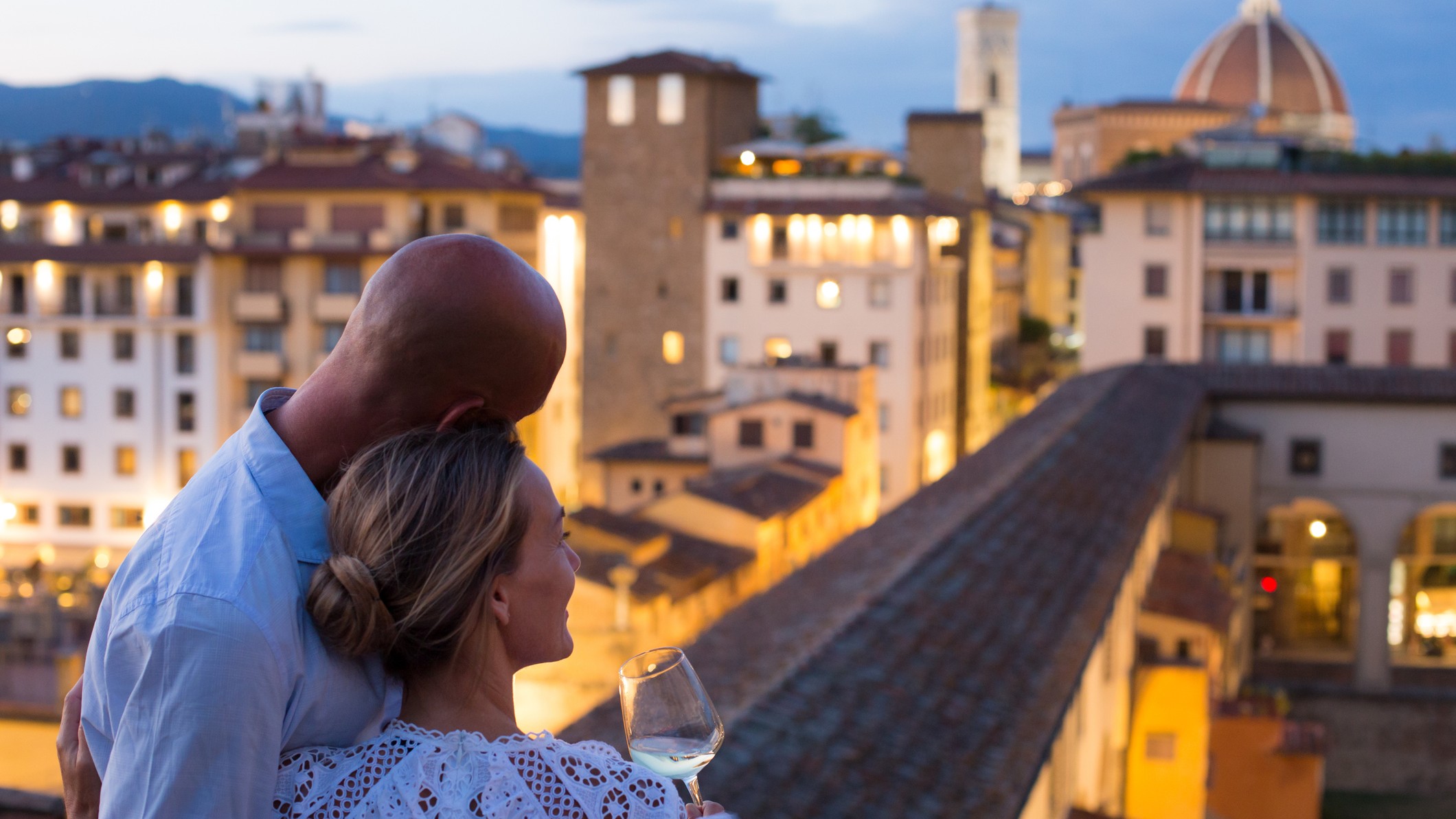 a couple enjoying the sights on a hotel balcony