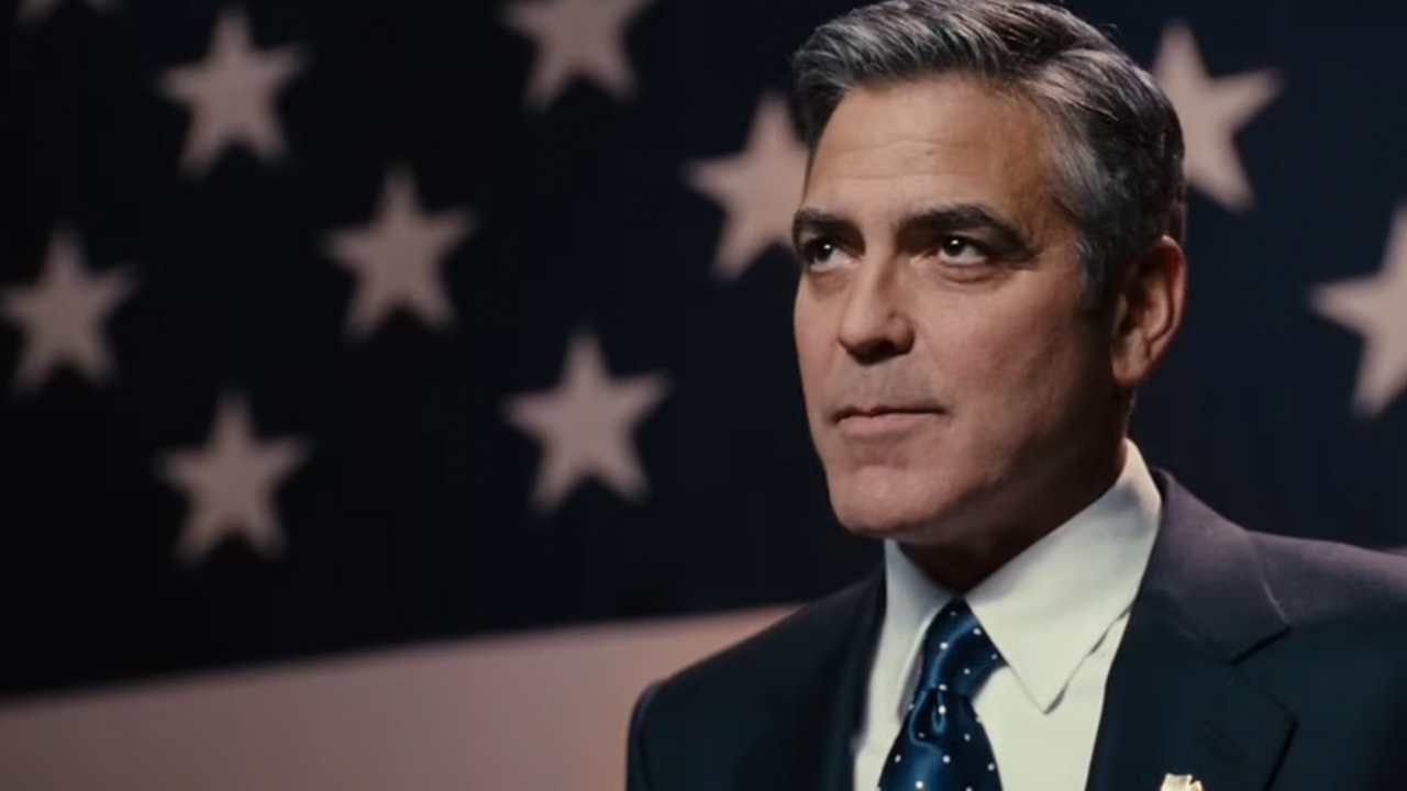 George Clooney standing in front of an American flag