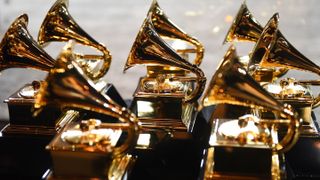 Eight Grammy awards lined up on a table